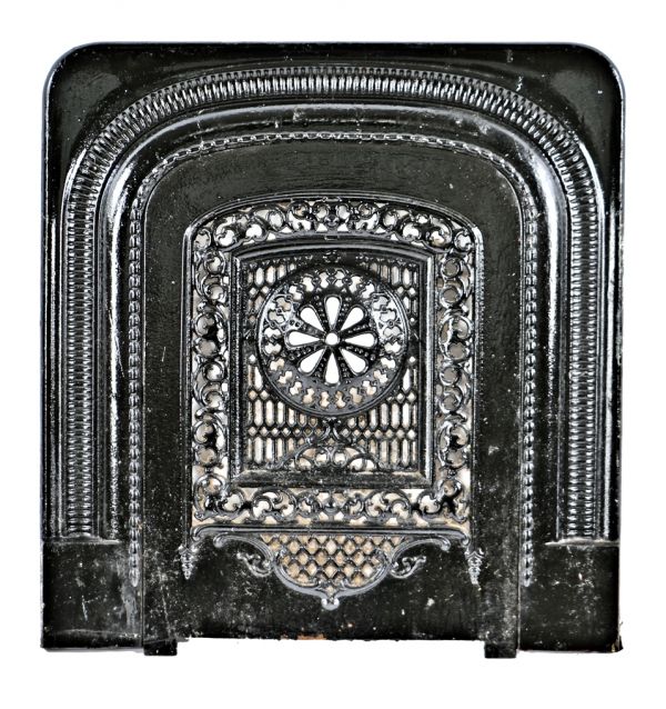 original c. 1874 interior residential ornamental cast iron two-piece fireplace summer cover and surround with mostly uniform black enameled finish 
