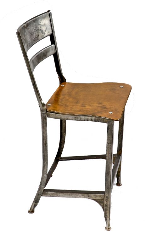 single all original c. 1940's pressed and folded "uhl art steel" four-legged stationary stool or chair with maple wood "saddle" seat and contoured metal backrest 