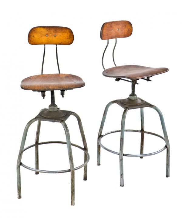 pair of original matching fully adjustable c. 1940's tubular steel plating factory stools with maple wood saddle seats and and slightly contoured backrests 
