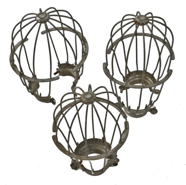 three original and weathered early 20th century antique american industrial "loxon" galvanized steel factory pendant light bulb guard or cage 