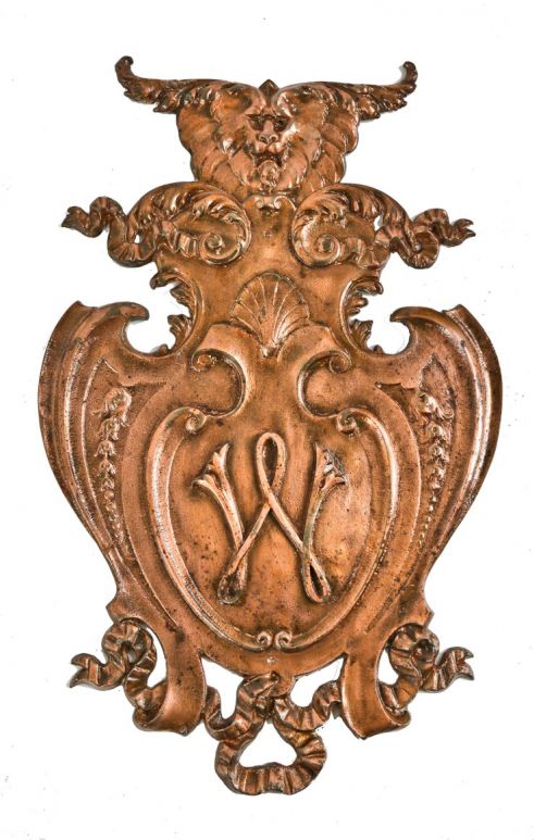 one of two matching c. 1890's interior copper-plated cast iron westcott hotel lobby wall-mount monogrammed cartouche with figural lion head