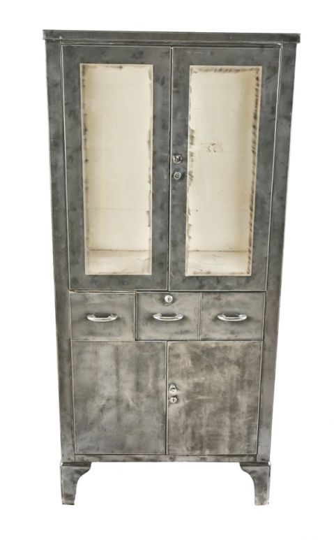 highly desirable oversized cold-rolled steel freestanding salvaged chicago antique american medical cabinet with two hinged cabinet doors, drawers, and glass sidelights 