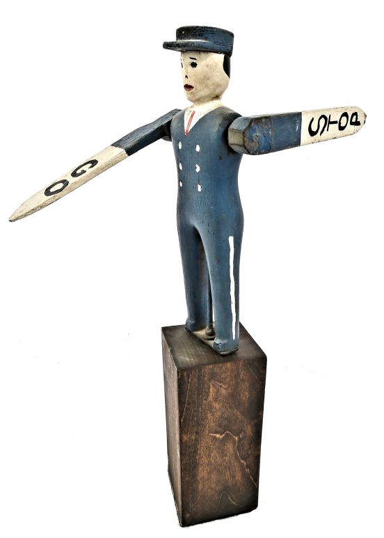 decommissioned early 20th century rare original allover crazed polychromed whirligig depicting a traffic officer with "stop" and go" rotating arms on a custom base