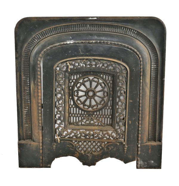 single 19th century ornamental cast iron salvaged chicago interior residential fireplace surround and matching summer cover with a mostly uniform black enameled finish 