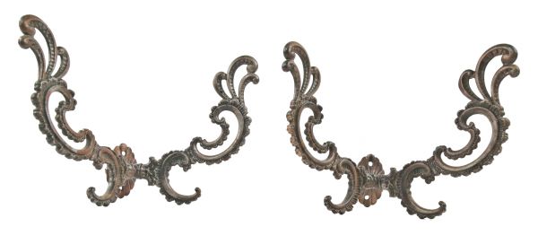 two matching late 19th century oversized american rococo style ornamental cast iron interior residential parlor hall tree hooks with elegant scrollwork 