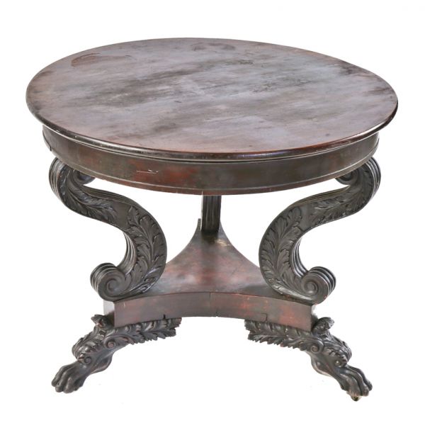 heavily carved three-legged 19th or early 20th century antique american solid walnut wood table with original darkly stained finish and intricately detailed clawfeet
