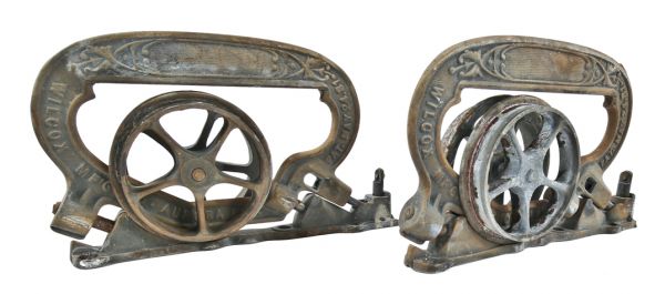 matching set of hard to find original interior residential ornamental cast iron single pocket door brackets or hangers with rollers and base plates