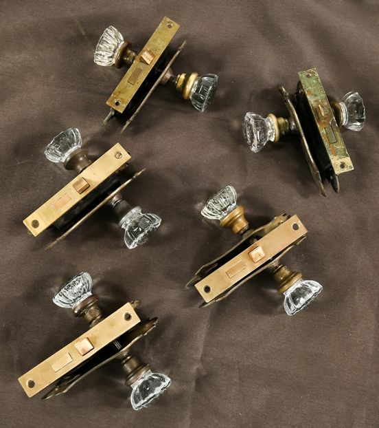 five all original and intact early 20th century interior residential chicago bungalow pressed glass doorknob sets with matching mortise locks and backplates  
