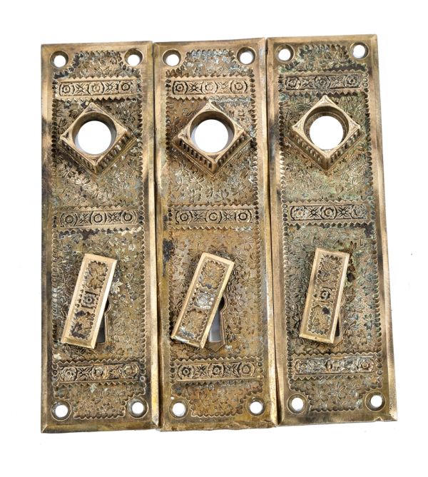 three original and intact ornamental cast brass antique american eastlake style "ivy" pattern interior residential doorknob backplates with swinging keyhole covers