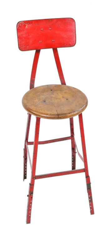 red painted 1940's pollard brothers four-legged riveted and welded steel adjustable height factory stool with contoured backrest and solid maple wood seat