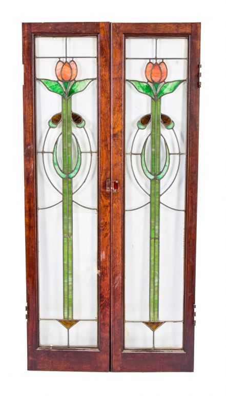 set of original early 20th century american art glass interior residential cabinet door windows featuring richly colored stained glass floral motifs 