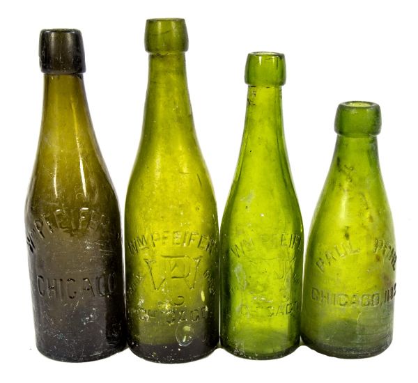 group of four 19th century original unearthed chicago privy pit richly colored green beer or ale bottles for paul pohl and william pfeifer
