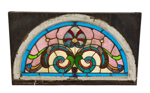 1880's richly colored arch top victorian era salvaged chicago residential stained glass lunette window with several jewels and textured cathedral glass 
