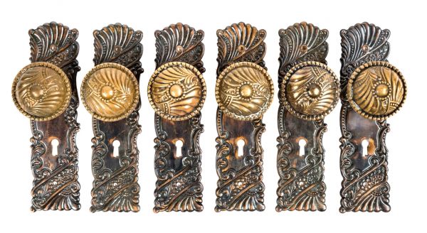 six matching original and intact salvaged chicago wrought brass "roanoke" pattern antique american doorknobs and matching backplates 