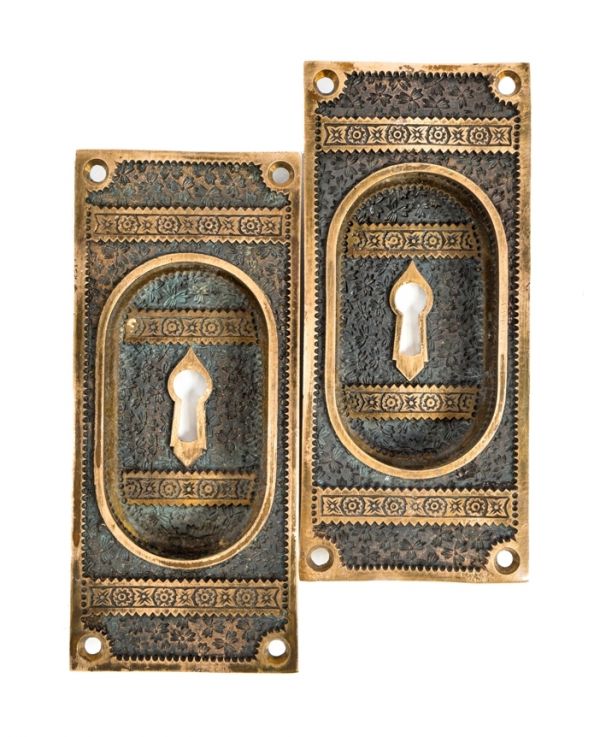 two matching oversized cast bronze "ivy" pattern interior residential salvaged chicago pocket door plates or escutcheons with mostly uniform patina