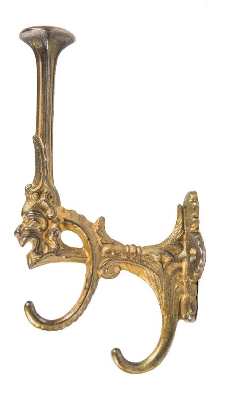 single oversized late 19th or early 20th century antique american  ornamental cast iron parlor tree hook with figural grotesque and old god  enameled