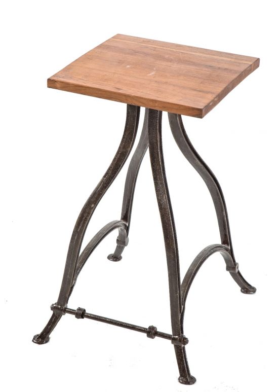 diminutive four-legged industrial side-table with early 20th century refinished brushed metal curvaceous legs and sanded and stained solid cherry wood top