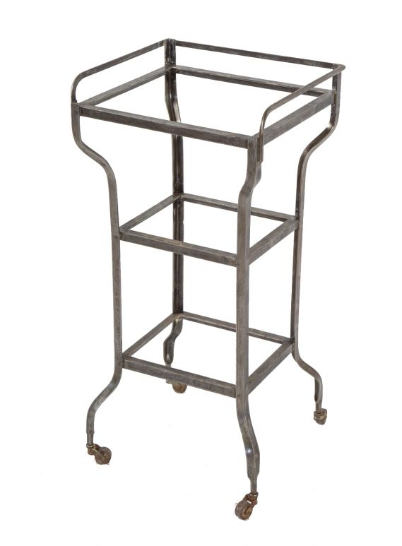 fully functional three-tier brushed metal antique american medical mobile hospital operating room cart or supply stand with intact swivel casters and glass plate shelves 