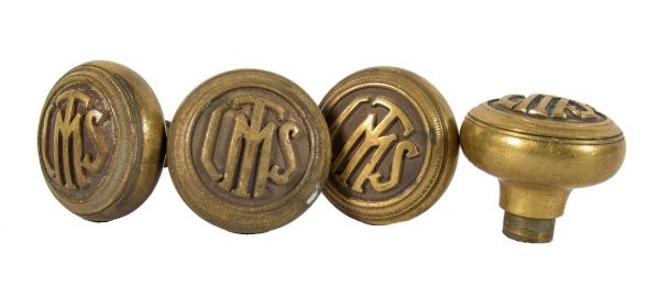 group of four matching interior logan square masonic temple building monogrammed cast brass doorknobs with nicely aged surface patina 