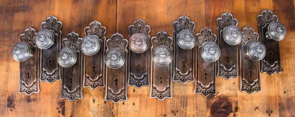 large lot of original early 20th century pressed or stamped ornamental copper-plated steel interior residential salvaged chicago matching backplates and doorknobs 