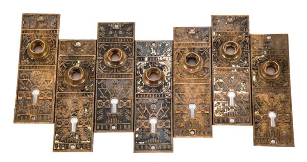 lot of original c. 1880's eastlake style "windsor" pattern interior residential cast brass passage door escutcheons with single keyholes and intricate floral motifs 