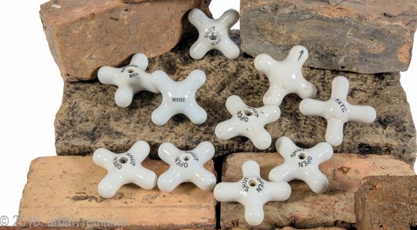 group of original late 19th or early 20th century salvaged chicago white china or porcelain cross-arm faucet handles for sink, shower, or bathtub 