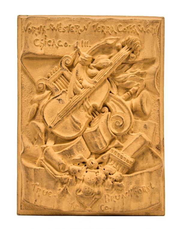 very rare early 1880's buff-colored ornamental terra cotta "salesman sample" chicago northwestern company plaque with unique assemblage of instruments 