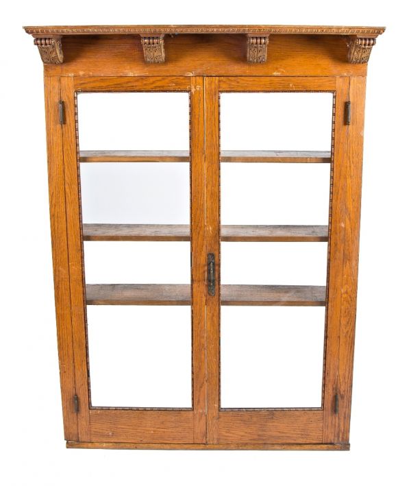 all original late 19th century golden oak wood freestanding double-door bookshelf cabinet with beveled edge glass and original ornamental hardware with matching skeleton cabinet key