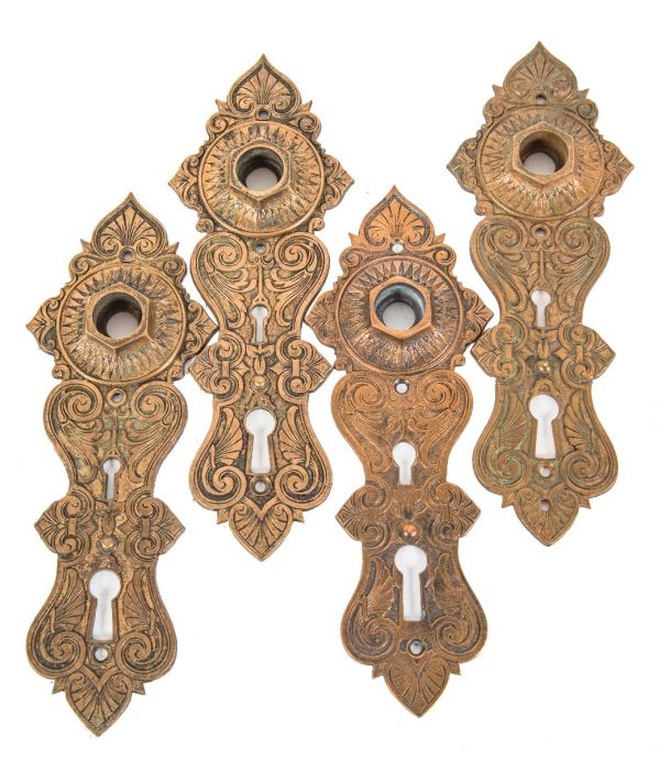 one of four matching original ornamental "compression cast" bronze metal 1870's american doorknob backplate