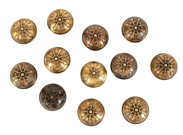group of twelve matching antique american ornamental wrought bronze dome-shaped embossed doorknobs with banded edges 