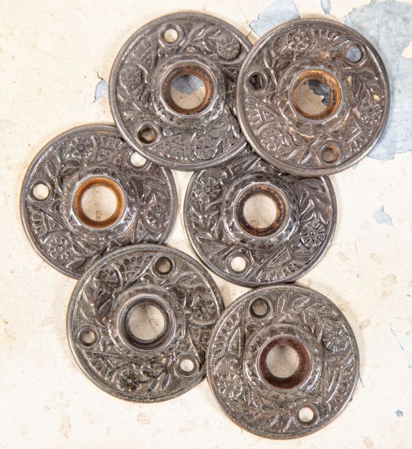 six matching original 1880s refinished ornamental american victorian-era passage door cast iron rosettes often found with black porcelain doorknobs 
