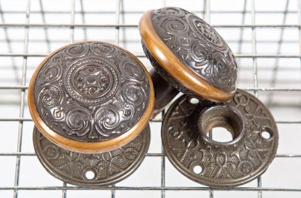 hard to find and highly stylized 1870s ornamental cast iron and brass doorknobs and matching rosettes salvaged from a post-fire chicago cottage 