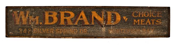 all original and nicely weathered william brand hand-painted polychromatic butcher shop exterior wood sign with intact eye hooks and uniform crazed finish 