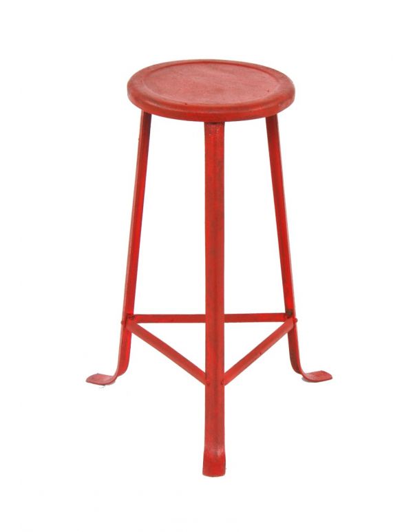 original antique american industrial red painted riveted joint angled three-legged stationary stool with pressed and folded metal seat