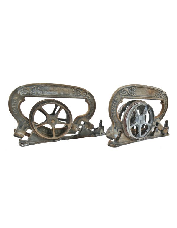 matching set of hard to find original interior residential ornamental cast iron single pocket door brackets or hangers with rollers and base plates