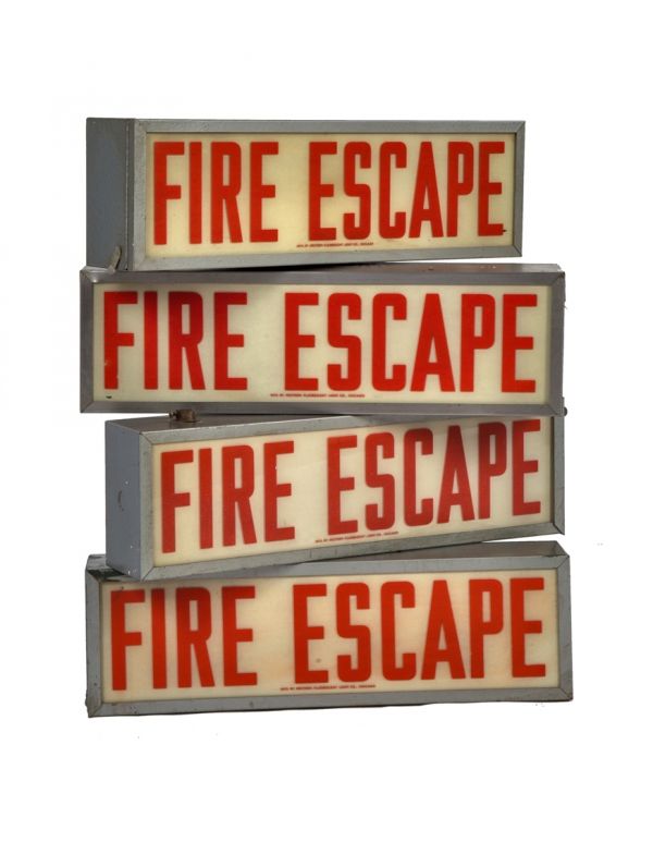 one of four matching c. 1940's vintage american industrial salvaged chicago factory illuminated "fire escape" wall or ceiling-mount sign with original enameled glass and steel housing  