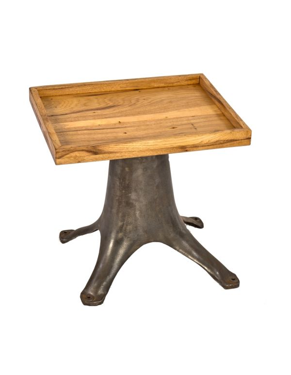 early 20th century american industrial heavy cast iron low-lying cream separator base repurposed as occasional or side table with newly added cherry wood top  