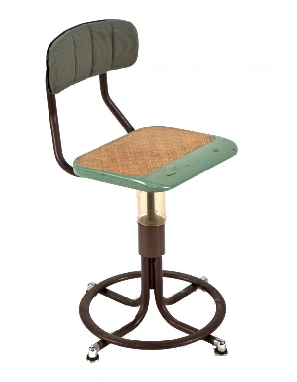 one of two nearly identical american depression era telephone company switchboard chairs or stools with adjustable height seat and curvaceous four-legged base