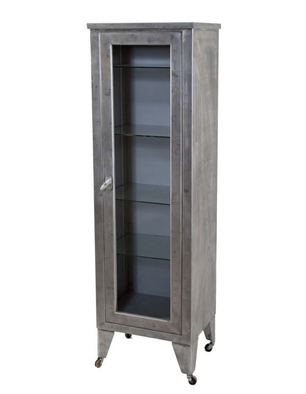 hard to find vintage american industrial tall and slender cold-rolled steel single door hospital room storage cabinet with removable glass doors and brushed metal finish 