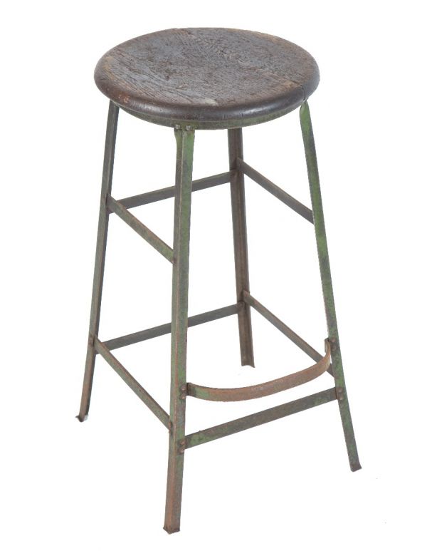 single vintage american industrial weathered and worn four-legged factory machine shop stool with solid oak wood seat 