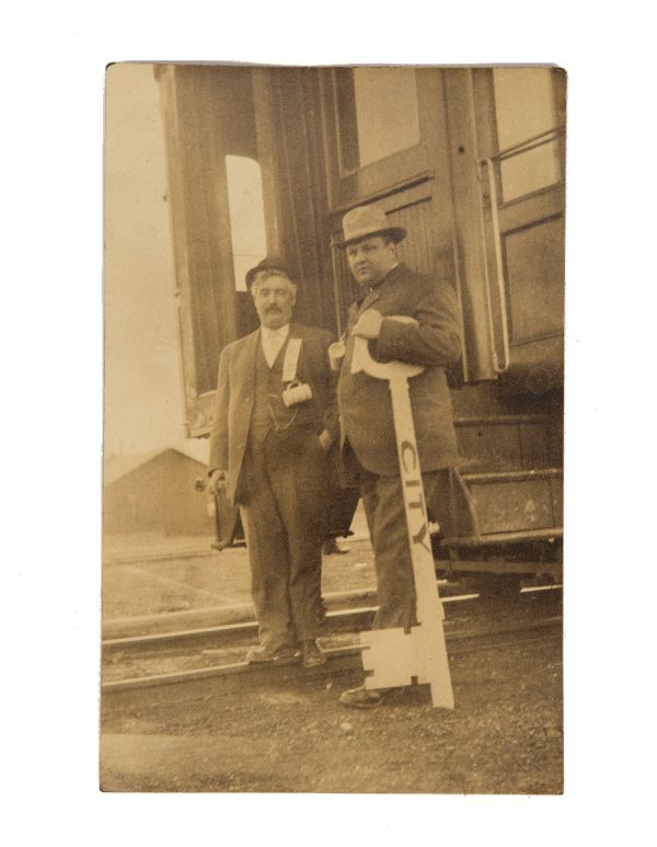 early 20th century real photo post card (rppc) of man holding oversized key to city 