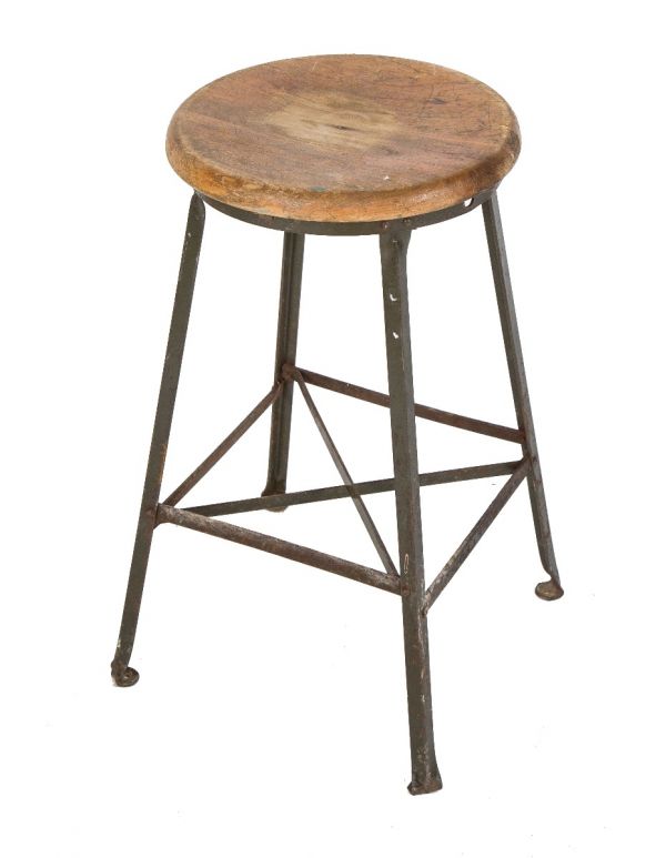 one of several salvaged chicago american depression-era angled steel stool with original wood maple top and riveted joints