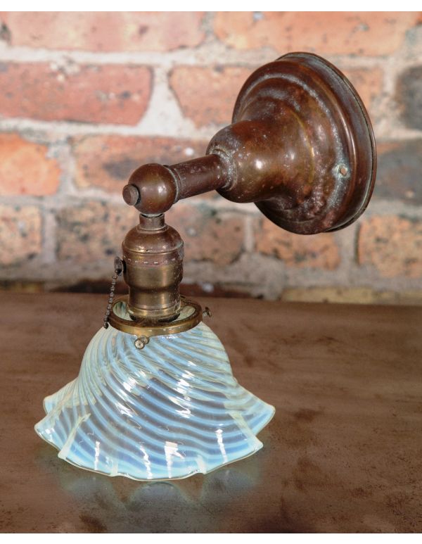 early 20th century antique american wall sconce with nicely aged patina and blue opalescent shade with ruffled edges