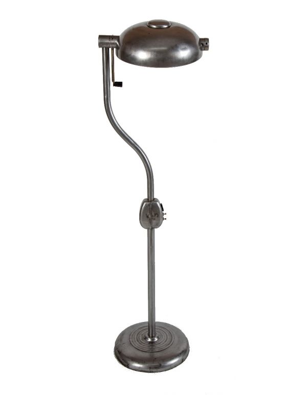 one of two matching original brushed metal hospital examination room adjustable floor lamps with pivoting handle