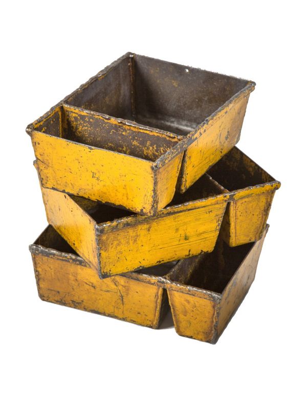 TWO matching heavily reinforced custom-built solid steel compartmentalized factory bins with weathered yellow finish  