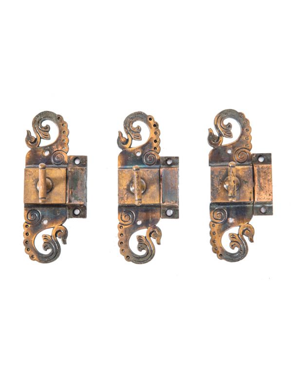 group of three matching original 19th century ornamental cast brass victorian cabinet door pulls with oxidized copper finish 
