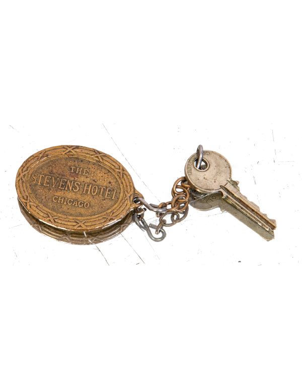 early ornamental cast brass downtown chicago stevens hotel emblematic oval-shaped key fob with rearing lion, shield, and ribbon with hotel name