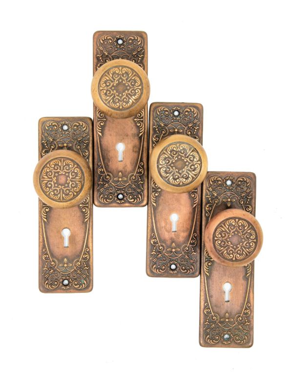 group of matching early 20th century heavy wrought bronze "alexandria" pattern salvaged chicago doorknobs and backplates 