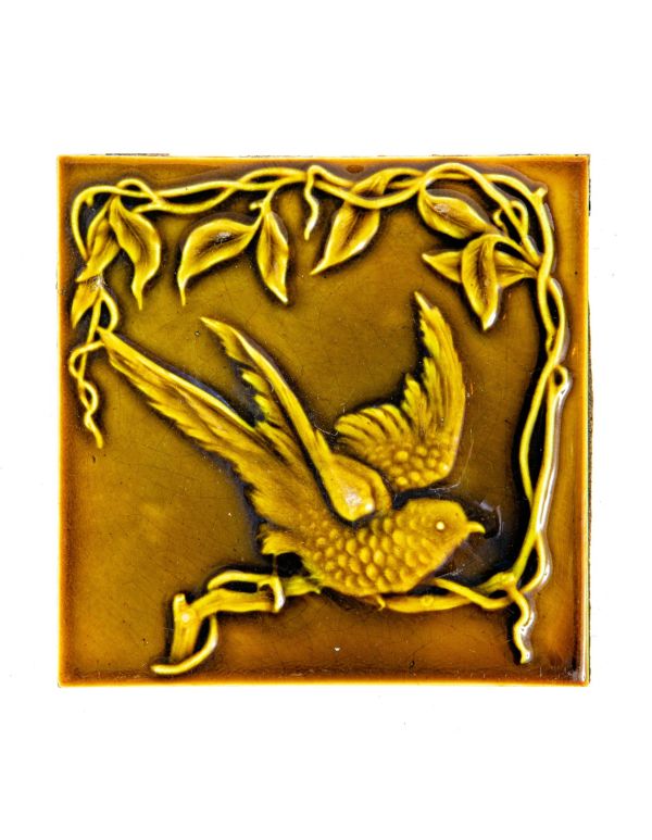 single original 19th century light olive-colored 6 x 6 inch majolica figural tile with winged bird and plant motifs