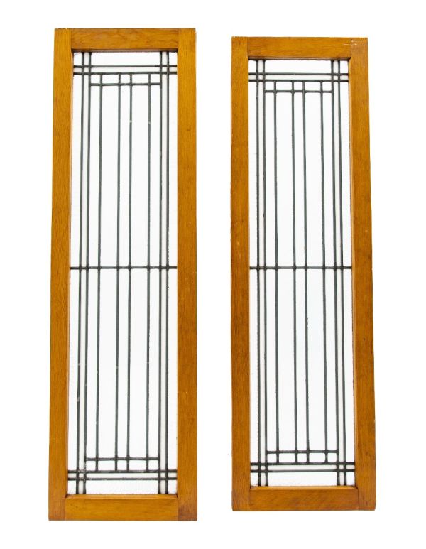 two matching early 20th century strongly geometric salvaged chicago leaded glass windows accentuated with white and cathedral roll borders